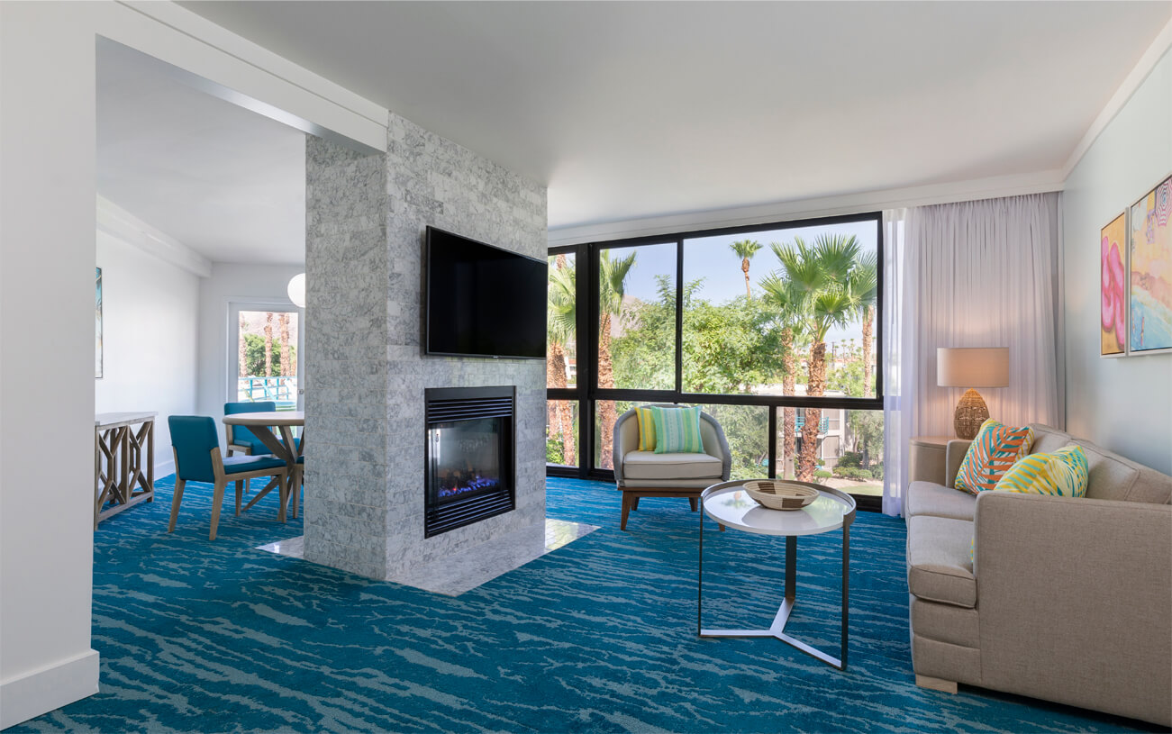 Lily-Suite-Living-Area a room with a fireplace and a television