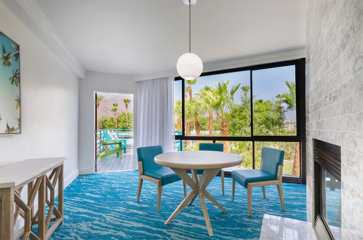 Lily-Suite-Living-Area- a room with a table and chairs