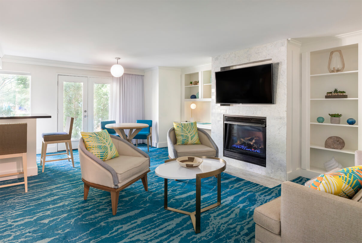 Sage Suite a room with a fireplace and chairs