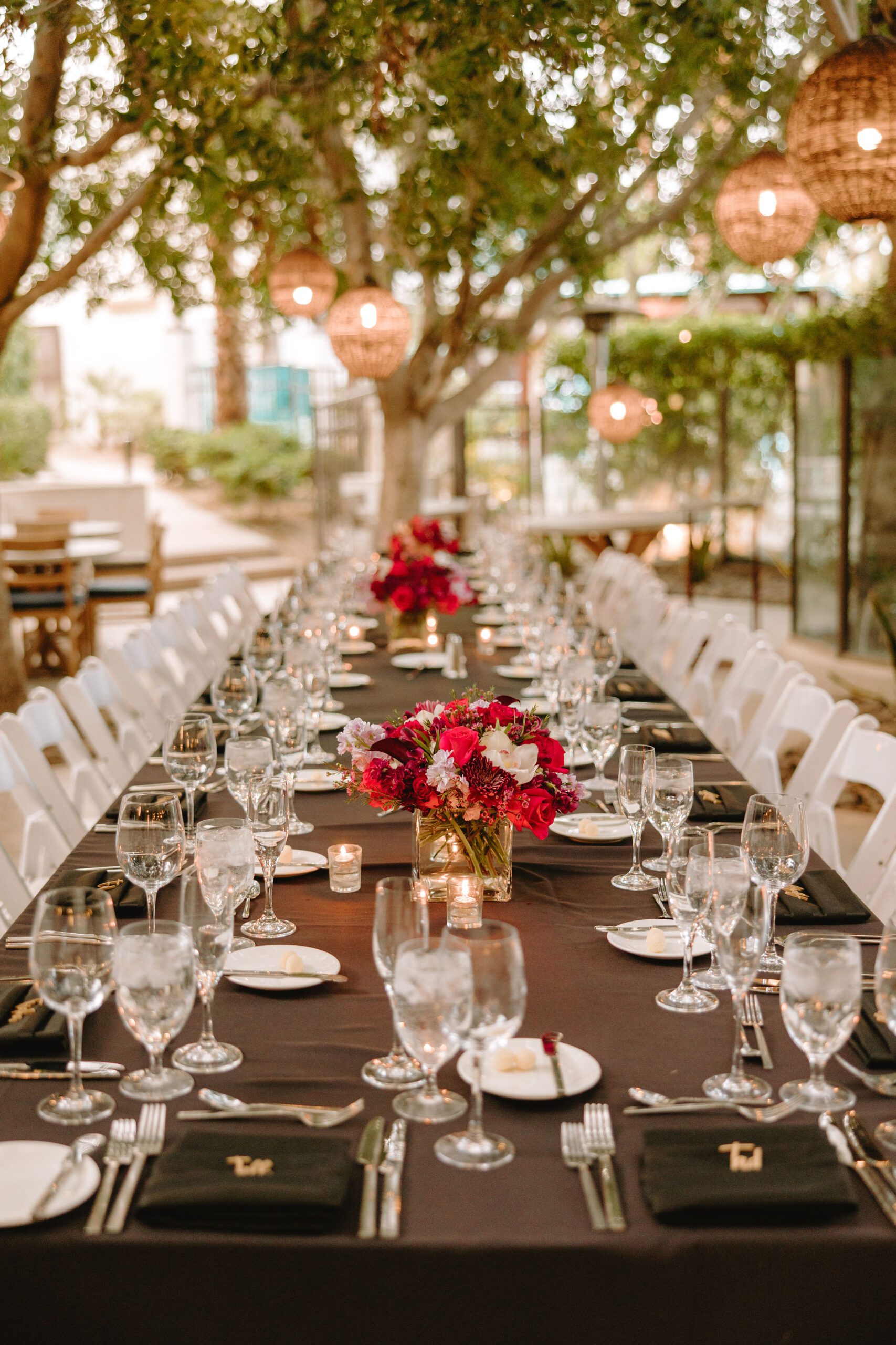 a long table with flowers and wine glasses