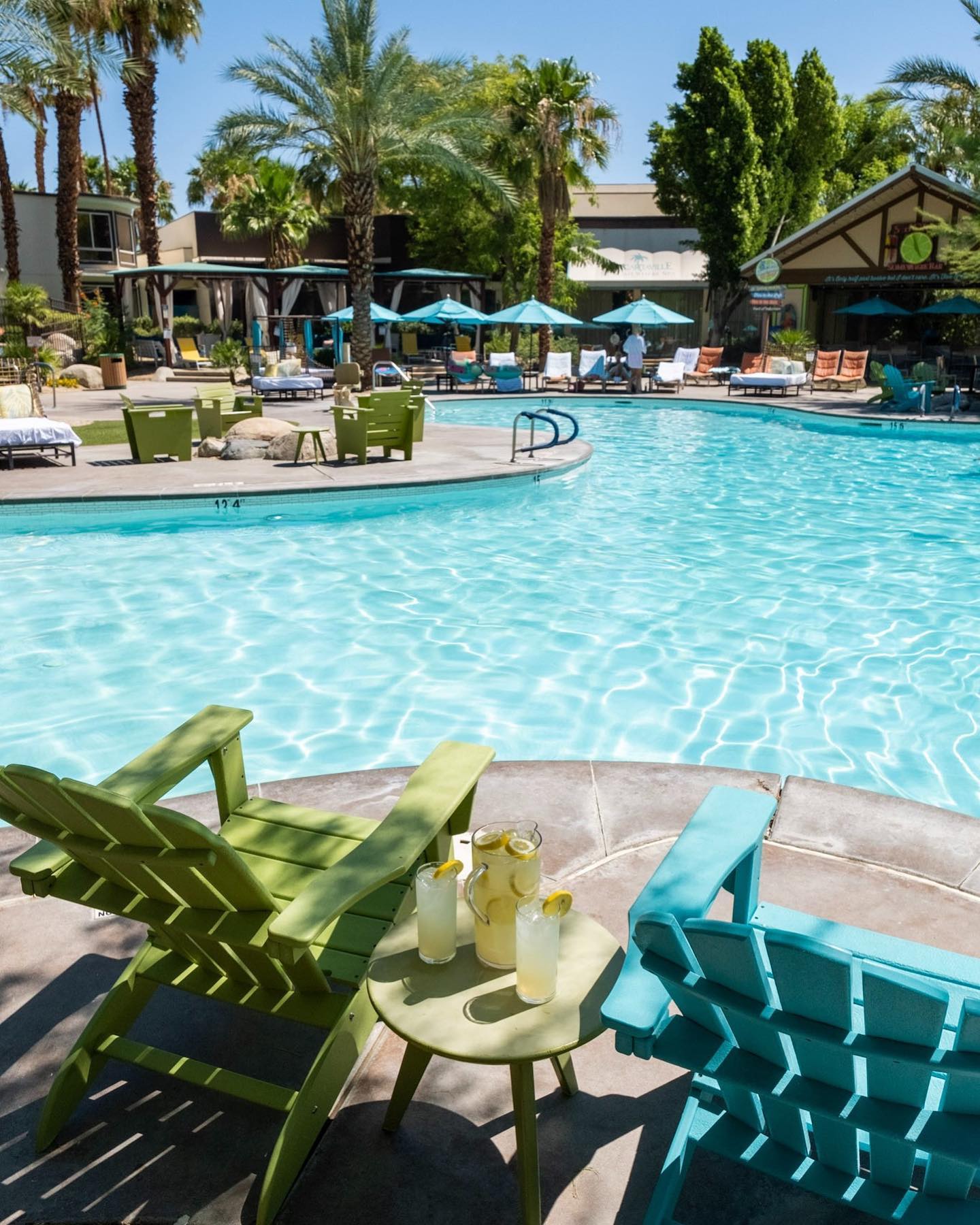 a pool with chairs and tables